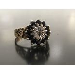 9CT GOLD CLUSTER RING WITH CENTRAL DIAMOND SURROUNDED BY 12 SAPPHIRES IN A HEAVY WEIGHT MOUNT