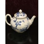 A WORCESTER BLUE AND WHITE TEA POT AND COVER PAINTED WITH FLOWERING TREES AND ROCKWORK,