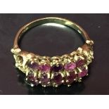 AN AMETHYST RING, HAVING THREE ROWS OF CLAW-SET STONES,