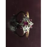 AN 9CT GOLD AMETHYST AND DIAMOND FLOWER HEAD RING