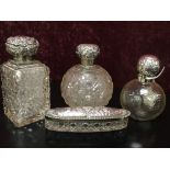 THREE SILVER TOPPED BOTTLES AND A SILVER TOPPED GLASS BOX