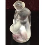 A OPAQUE ART GLASS FIGURE OF A KNEELING NUDE WOMAN WITH A SWAN UNDER HER ARM,