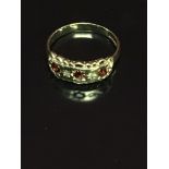 9CT GOLD GYPSY STYLE RING SET WITH ORANGE STONES AND DIAMONDS