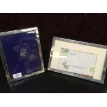 TWO SILVER PLAIN FRAMED PHOTOGRAPH FRAMES (ONE GLASS A/F)