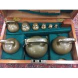 A MAHOGANY CASED SET OF 16 BRONZE SPHERICAL LOCAL STANDARD WEIGHTS, 56LB > 1/2 DRAM,