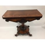 A VICTORIAN ROSEWOOD PEDESTAL FOLDING TOP TEA TABLE WITH CIRCULAR BASE STANDING ON A SCROLLED FOOT