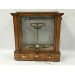 A GLAZED MAHOGANY CASED BRASS BEAM SCALE ENGRAVED BOROUGH OF PLYMOUTH TO WEIGH 1OZ BY OERTLING E.V.