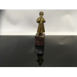 A COLD PAINTED BRONZE OF A GIRL IN GOLD DRESS MOUNTED ON MARBLE PLINTH 10CM AF