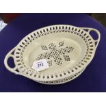 A SHORTHOSE CREAMWARE STRAINER BASKET AND STAND