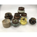 A COLLECTION OF 8 CERAMIC / STONEWARE TOBACCO JARS WITH 'SCREW DOWN' LIDS