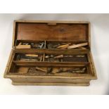 A PINE CARPENTER'S CHEST CONTAINING WOODWORKING TOOLS - 4 REMOVABLE TRAYS - SCRIBES, MALLETS,