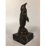 A SMALL BRONZE PENGUIN BEARING STAMP PRECOURT FRANCE 12CM MOUNTED ON MARBLE PLINTH