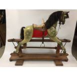 A SUPERB VICTORIAN PAINTED ROCKING HORSE WITH LEATHER BACK AND HORSEHAIR MANE AND TAIL MOUNTED ON A