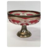 A ETCHED CRANBERRY GLASS BOWL WITH WHITE METAL MOUNT AND WHITE METAL SPREADING BASE