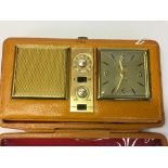 1960'S TRANSISTOR BEDSIDE RADIO ALARM BY 'ESTIMA', FOLDS INTO LEATHER FINISHED CASE.