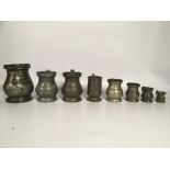 A GROUP OF 9 GRADUATED ASSORTED PEWTER JUG/TANKARD MEASURES