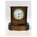 VICTORIAN WALNUT AND EBONISED CLOCK IN A SERPENTINE SHAPED CASE,