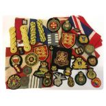 A COLLECTION OF MILITARY CLOTH BADGES AND 5 FLAGS