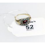 A mid 19th century garnet and seed pearl cluster ring, with carved and engraved shoulders and a