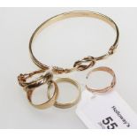 A 9ct gold open knot bangle, together with a bi-coloured 9ct ring, two knot rings and two further