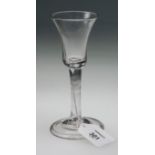 An 18th century trumpet wine glass, with plain stem over a folded dome foot, 15cm, c1750s