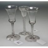 An 18th century probably Scottish bell bowled wine glass, with wrythen stem over a folded domed