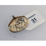 A speckled gold quartz pendant, oval with yellow metal mount and scrolling pendant fitting