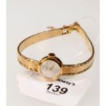 A lady's 18ct gold wrist watch, the circular dial signed Gigandet, with integral flexible bracelet