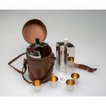 An Art Deco design leather cased nickel plated segmental spirit decanter, with nesting nip cups