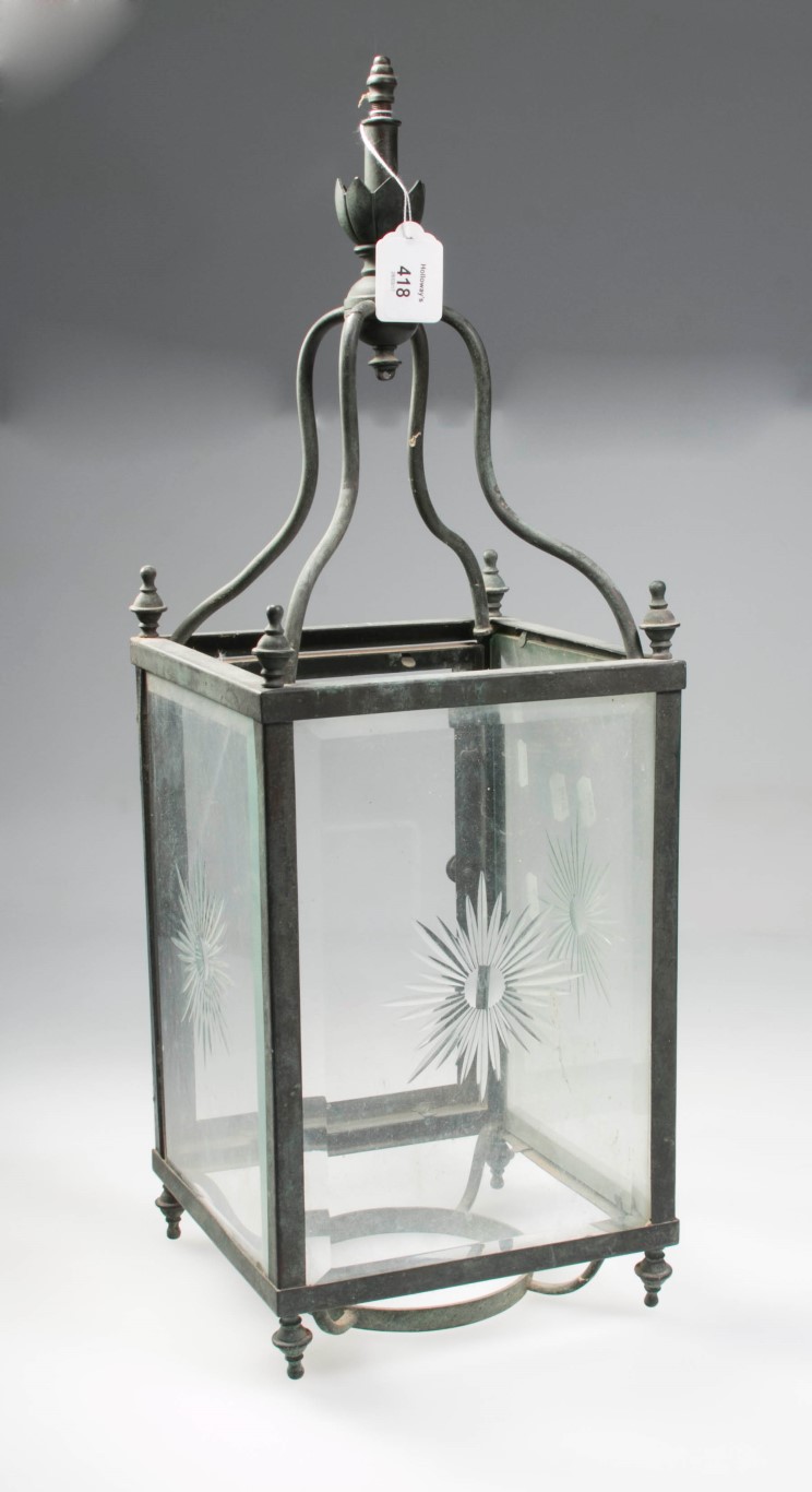 A Victorian clear glass rectangular hall lantern, with star cut detail, the copper frame with urn