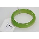 A 20th century circular green jade bangle, of rounded section, 8cm diameter (outer)