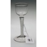 An 18th century double cotton twist stemmed wine glass, with small rounded bowl over a spreading