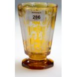 A late 19th century Bohemian amber flashed and etched 'Spa-Glass' of tapering panelled form, bearing