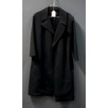 Loewe, a lady's black trench-style coat and leather belt en suite, with wide lapels and uncuffed