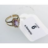 An amethyst cluster ring, marquise shaped amethyst to bifurcated shoulders in 9ct gold mount