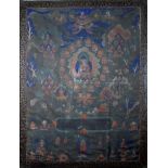 A Tibetan Thangka/Thanka, painted with central Buddha on a lotus throne in colours on a cotton
