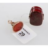 A 19th century carnelian intaglio seal, with reeded mounts, together with a miniature cut glass