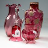 Nine pieces of Victorian and later cranberry glass, including table bell, wavy-rim jug, two enamel