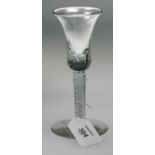An 18th style century double open cotton twist stemmed wine glass, with bubble inclusion bell