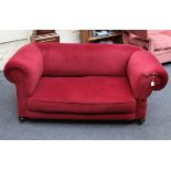 An Edwardian drop arm two seater 'Chesterfield' settee, in wine velour