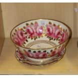 An early 19th century English porcelain bowl, hand decorated with bold pink roses, gilt leaves and