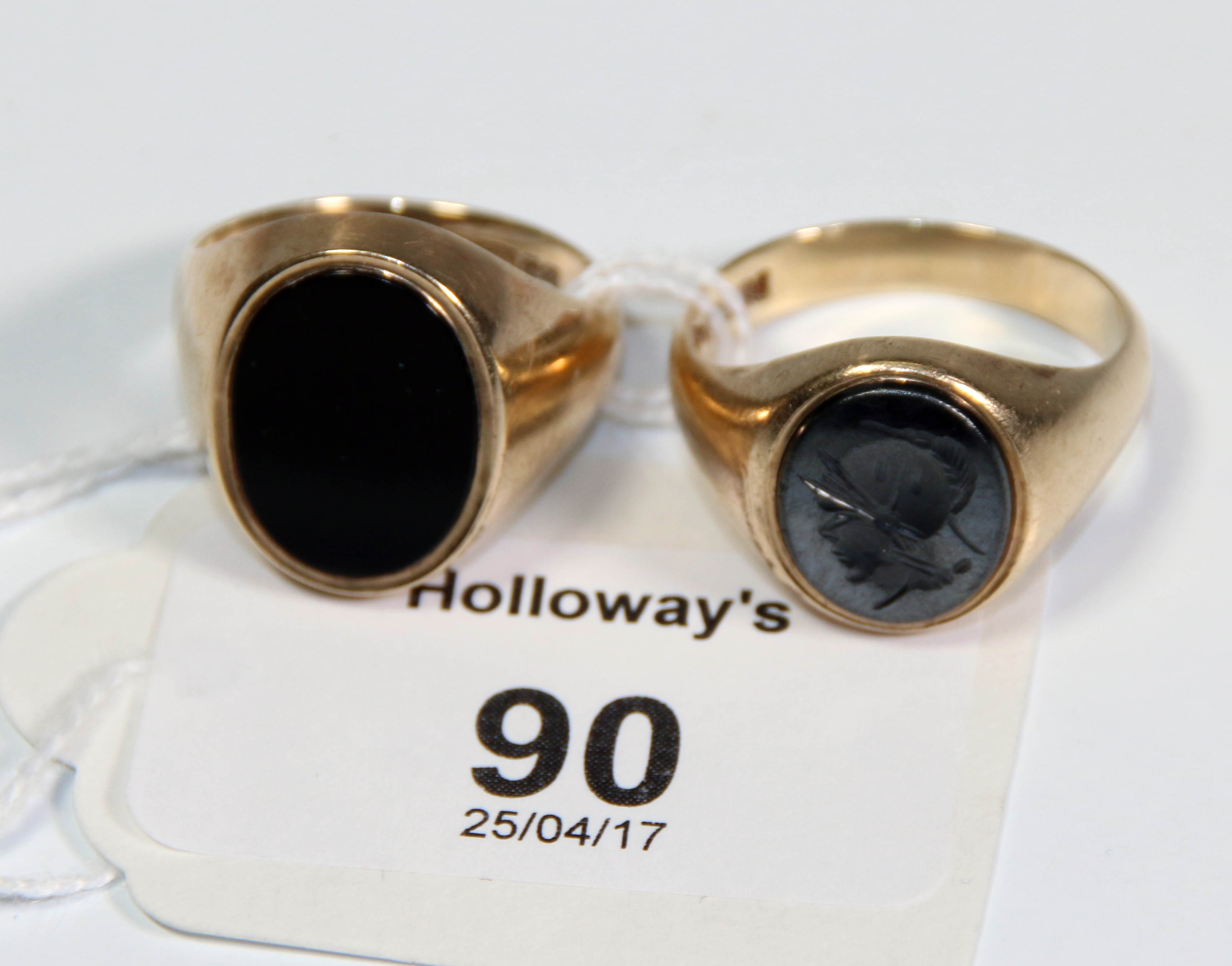 A gentleman's onyx mounted dress ring, and one similar