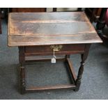 An 18th century oak side table, the planked top with moulded edge over frieze drawer with later