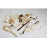A small collection of 19th century ivory parasol handles, beads, figures, and other items