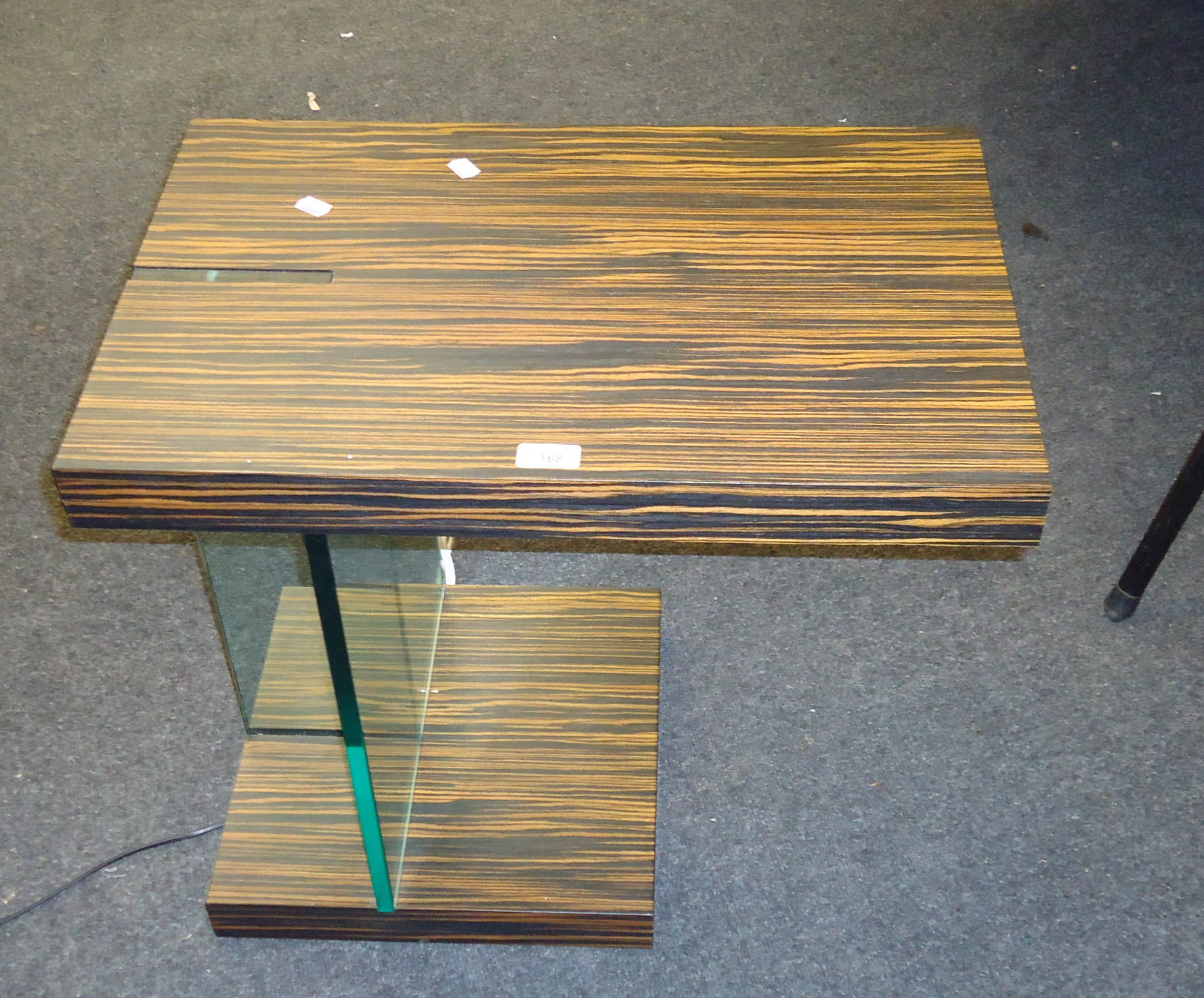 A designer zebrano and plate glass illuminated side table