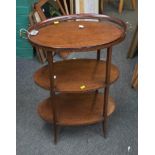 A George III style mahogany, oval three tier etagere tray table, with parquetry gallery and glass