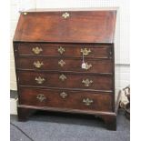 A George III mahogany fall front writing bureau, with simple fitted interior, over four long