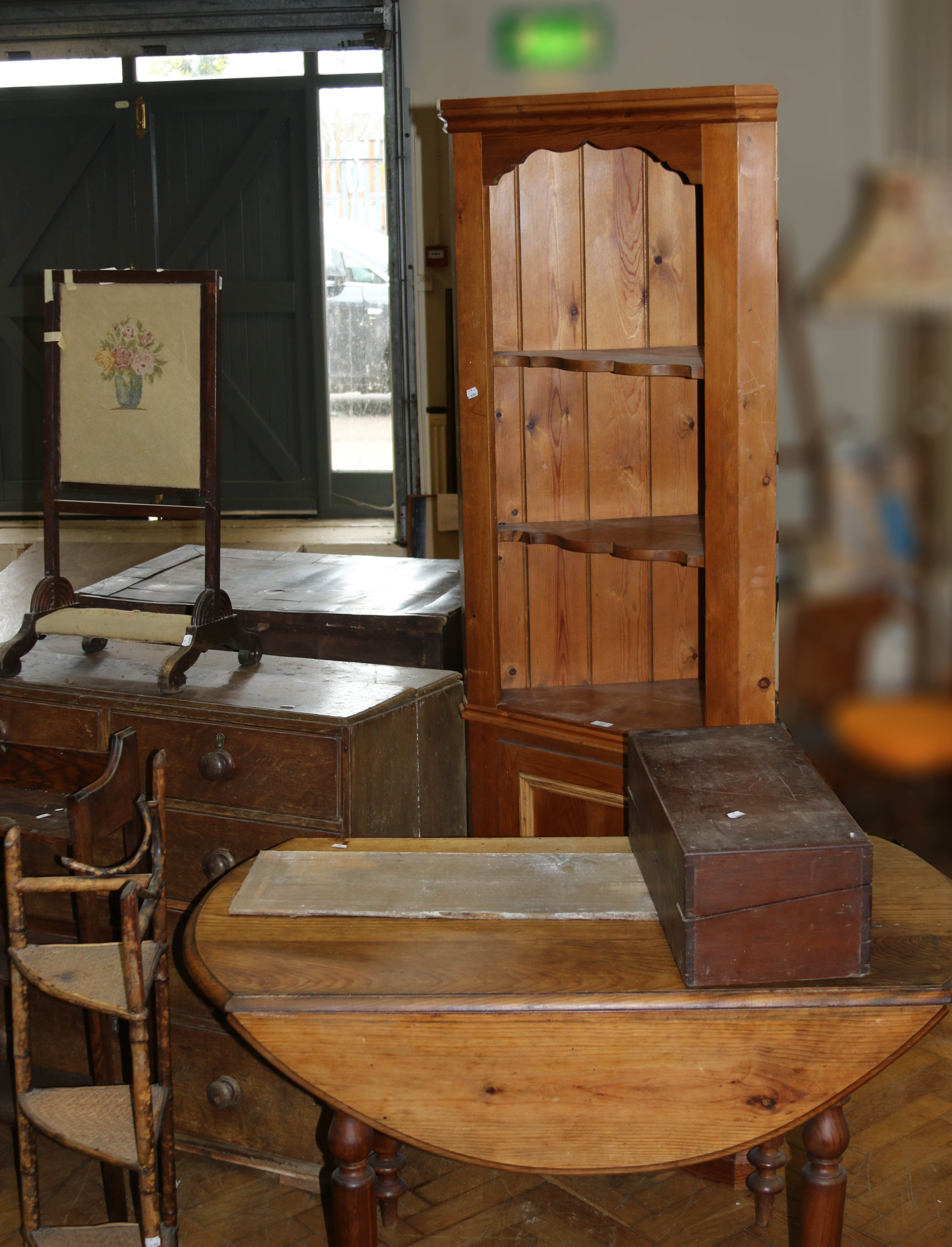 A pine freestanding corner cupboard, together with a pine drop leaf dining table, oak chest of