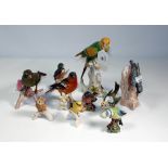 A collection of ten ceramic birds, including a Goebel Bullfinch, Greenfinch, Beswick Blue Tit, etc