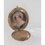 An early 19th century mourning locket, with hinged cover opening to reveal a head and shoulders